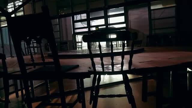 Wooden installation with round table and chairs