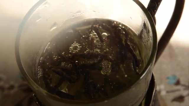 Pouring Hot Water in a Glass, Putting Tea Leaves, Brewing Tea in a Cup. Close up