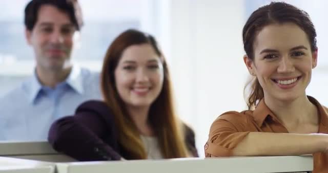Smiling  business people leaning on cubicle walls