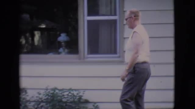 1966: older gentleman walking outside of his house with pet CLARKSDALE, ARIZONA