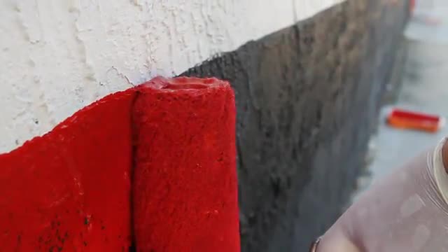 A paint roller applying...