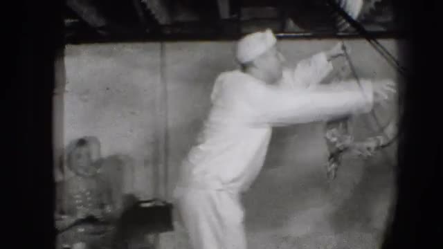 1941: sailor offers woman his handkerchief in bare room NEW YORK