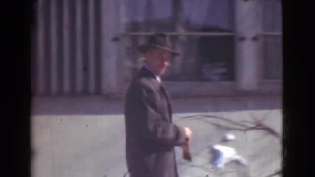 1939: man off to work, what a gentleman. look at those cars! LOS ANGELES, CALIFORNIA
