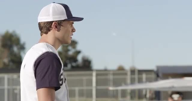 MS Young man standing on baseball diamond