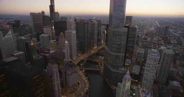 WS POV Skyscrapers with roads and bridges in city at dusk