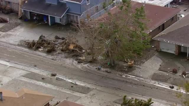 WS POV AERIAL ZI Car stuck in a tree after natural disaster / United States
