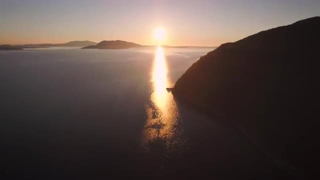 Drone Shot Slowly Floating to Sunset on Ocean Island Horizon