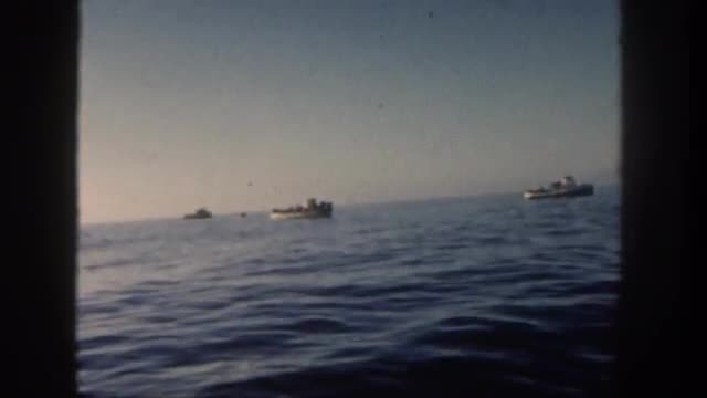 1962: older gentleman and ladies on boat watching cruise ship go by on the water SAN PEDRO, CALIFORN
