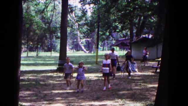 1963: a family arriving at a park with chairs, food and blankets to have a picnic. COLD SPRINGS, NEW