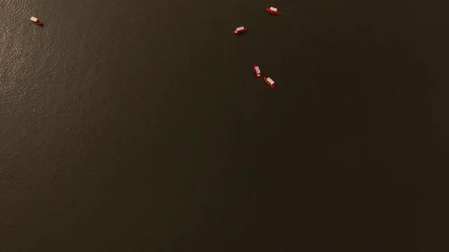 Aerial shot push in to boats riding in the lake