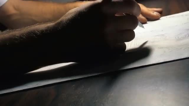 Painter draws sketch on the table