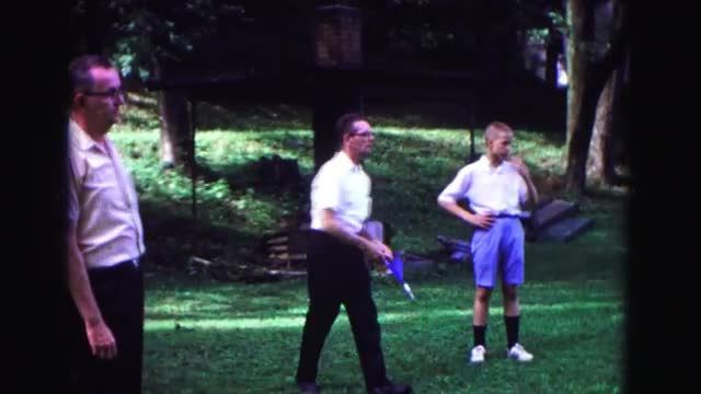 1971: older man throws lawn darts with friends at a park OMAHA, NEBRASKA