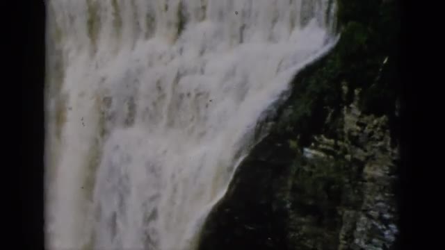 1952: foaming waterfall in forest near lodge on a sunny day. CAMDEN, NEW JERSEY
