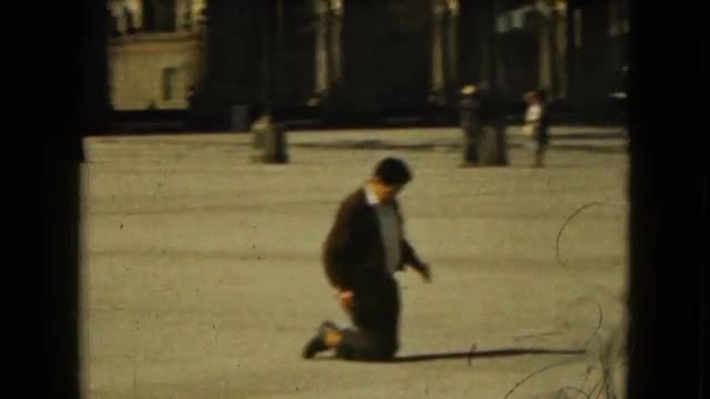 1962: a man and his family walking on the pavement with their knees MEXICO