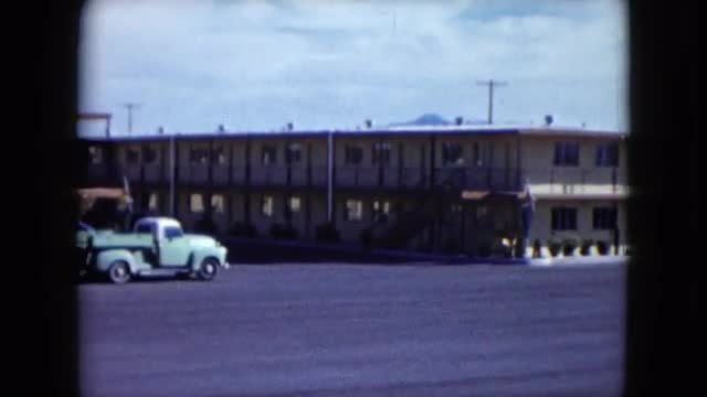 1959: the parking lot of a two story motel with mountains in the distant background LAS VEGAS, NEVAD