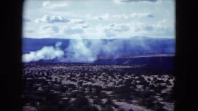 1959: vast arid land with sparsely distributed trees and mountain range ARIZONA