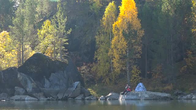 Young Couple in Love on Lake in Woods Near Tent. Panorama Autumn Leaf Sunny Day. Background of Yello