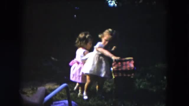 1954: two young girls playing with a baby doll and baby doll carriage HICKSVILLE, NEW YORK