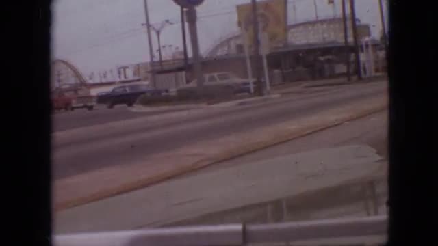 1968: car driving by an amusement park and stopping at a stop light MISSOURI