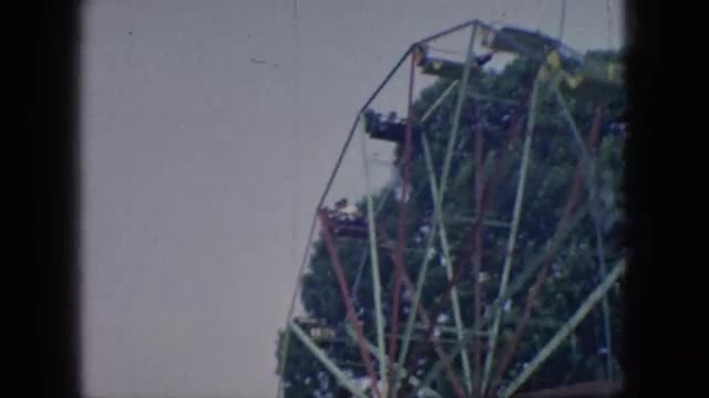 1966: crowded park on fair day at the amusement park enjoying ferris wheel rides on a sunny day NEW 
