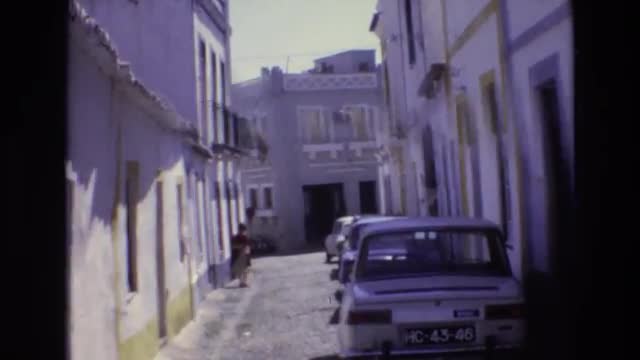 1972: cars parked alongside trees pathway PORTUGAL