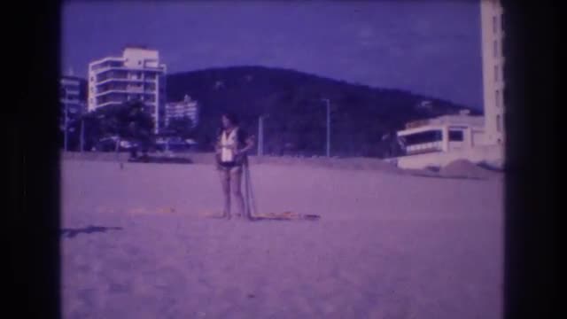 1982: adventurous woman preparing to go paragliding at a tropical beach resort. ACAPULCO MEXICO