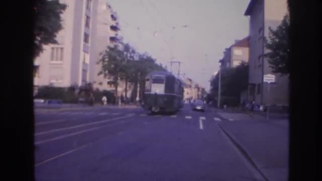 1967: some traffic on road with a tram moving on the opposite side. FRANCE