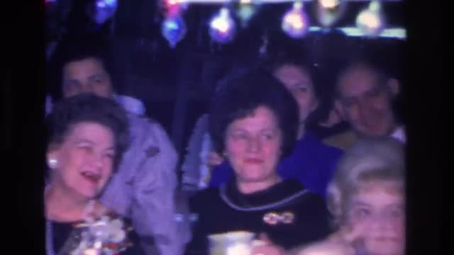1966: family friends celebrate giving laughter filled toasts with gifts presents and drinks HOBOKEN 