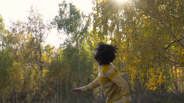 Slow Motion Girl Acrobatics Background Leaf Fall. Sunny Day.