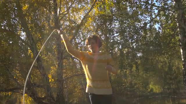 Slow Motion Girl Acrobatics Background Leaf Fall. Sunny Day.