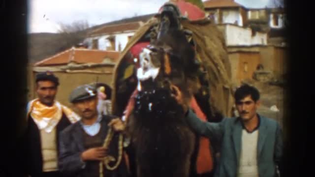 1962: three men gathered around a camel foaming at the mouth IZMIR TURKEY