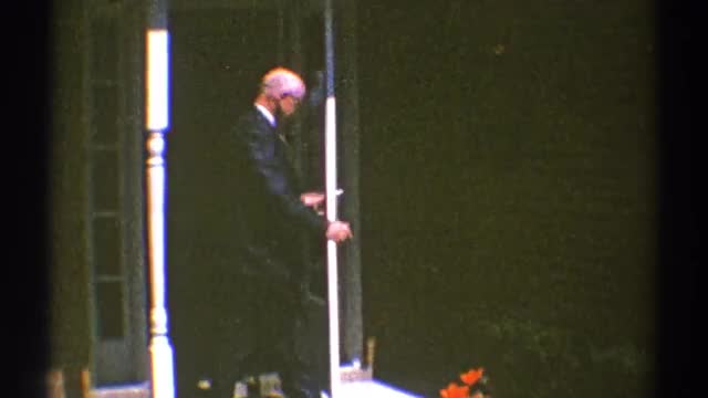 1969: well-dressed man and two boys push open storm door and walk onto pathway CLARENDON HILLS ILLIN