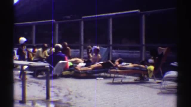 1969: beachgoers relaxing on lawn chairs COLORADO
