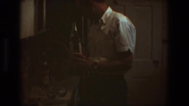 1968: an older gentleman holding up two bottles of alcohol to the camera TOLEDO OHIO