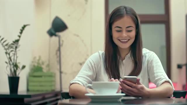 Woman Using App on Smartphone in Cafe Slow Motion