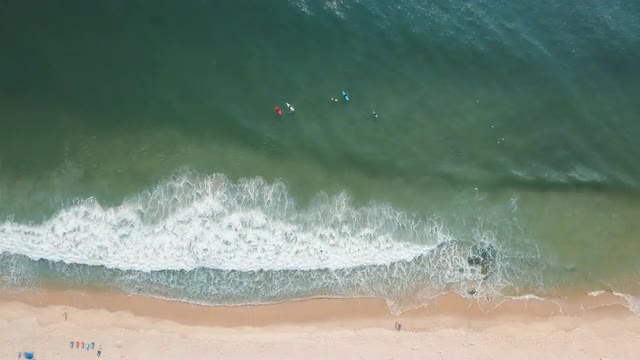 High angle view of surfers in ocean waves
