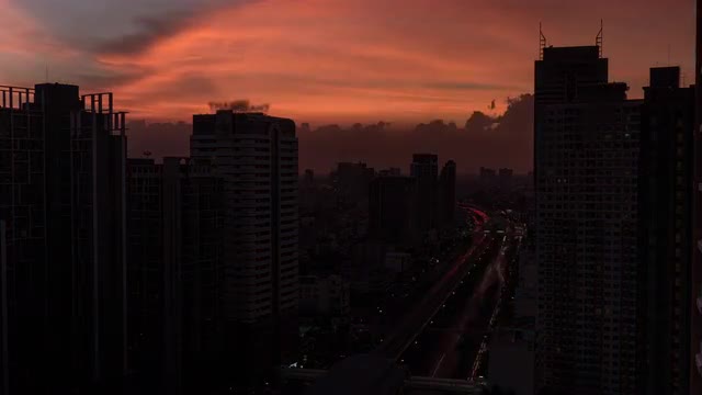 Time lapse shot of cityscape with skyscrapers, buildings and industrial smog under city on the backg