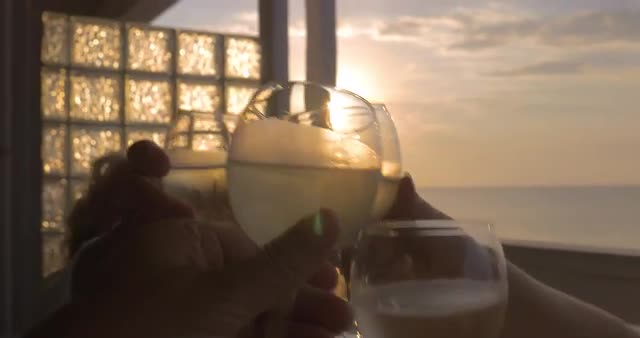 Family celebrates raising their glasses of white wine in city Perea, Greece