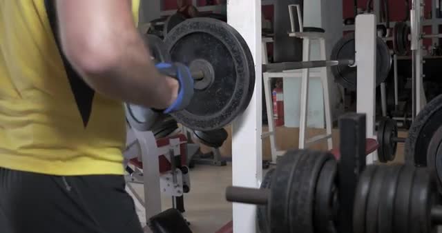 Sportsman flexing chest muscles on bench