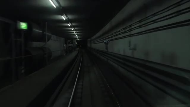 Cabin view of train moving in dark subway tunnel