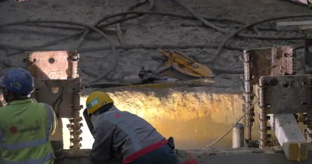 View of worker welding reinforcement of constructed building. Hong Kong, China