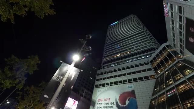 Timelapse of people in the street by highrise building. Seoul, South Korea