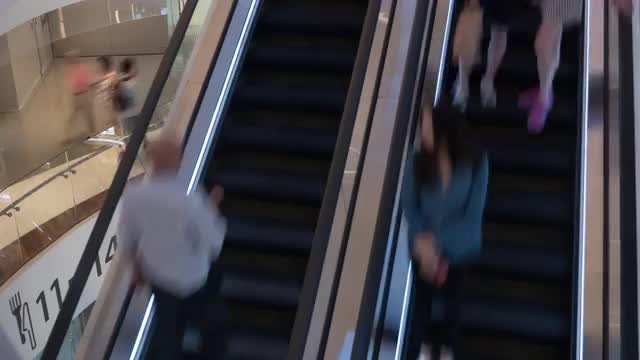 Timelapse of escalators with people in trade centre