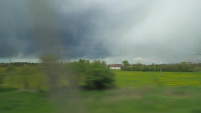 Shot of moving countryside landscape from window of train, Vienna, Austria