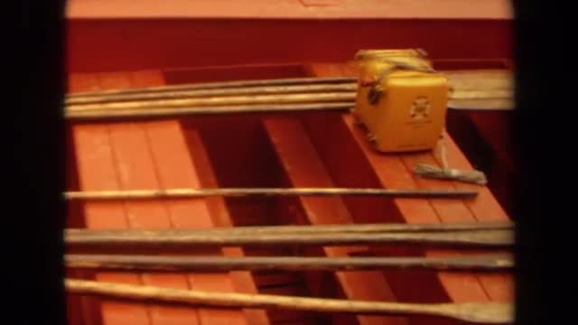 1971: various rods and poles sit inside an orange and brown boat LONG BEACH CALIFORNIA