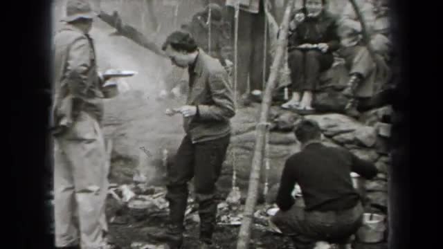 1938: several people outside around a campfire eating NEW YORK 1938: several people outside around a campfire eating NEW YORK