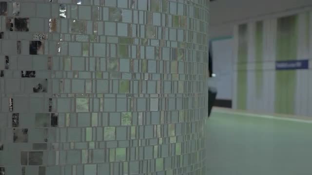 Man with cell and suitcase at subway station