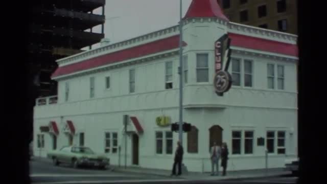 1977: a bar named "club 24" sits on a corner in a city ALASKA
