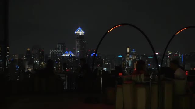 Cafe on the roof with view to night city of Bangkok, Thailand
