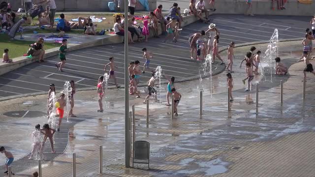 Yound kids enjoy  playing in fountains near the Guggenheim